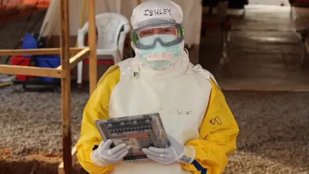 Health worker using a decontaminatable tablet in an Ebola treatment unit